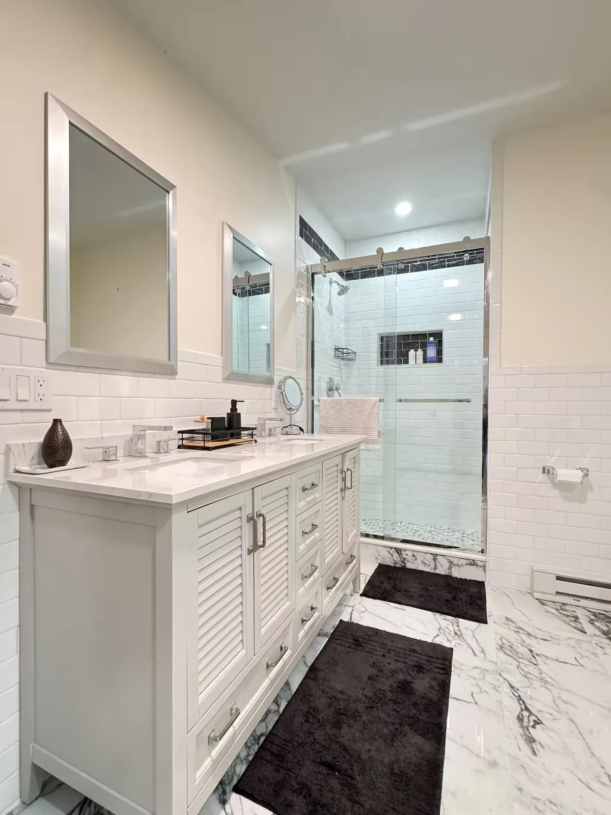 Bathroom with double vanity and glass shower