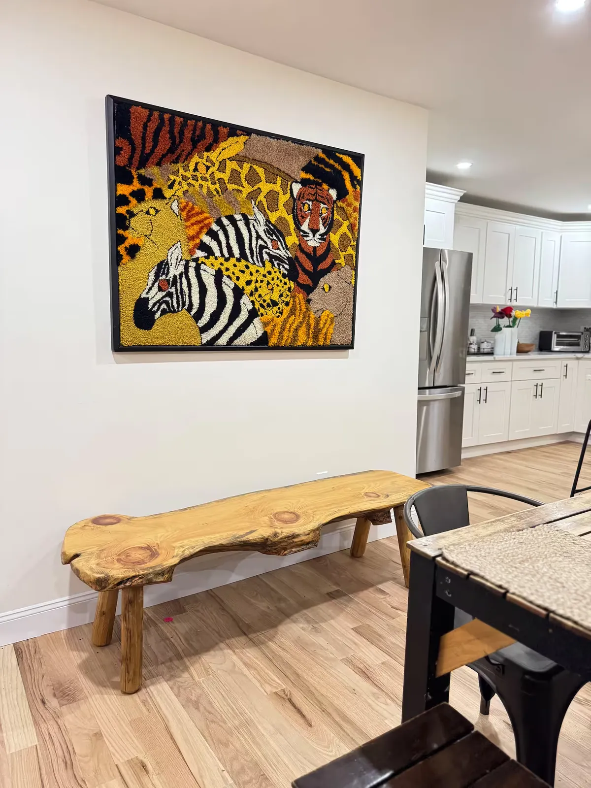 Dining area with live-edge bench and artwork