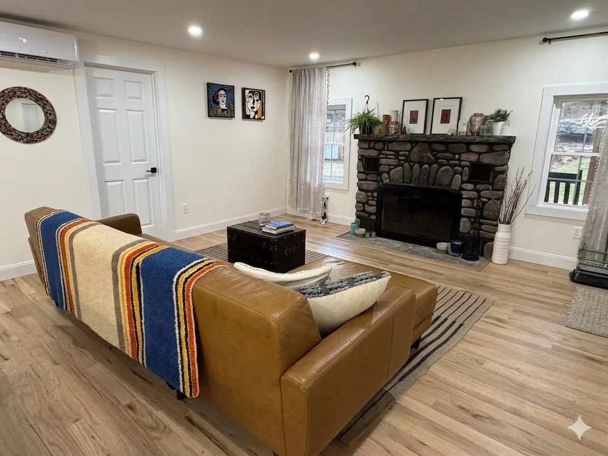 Living room with leather sofa and stone fireplace